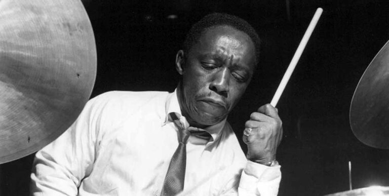 Black and white photograph of Art Blakey playing the drums.