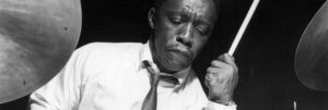 Black and white photograph of Art Blakey playing the drums.