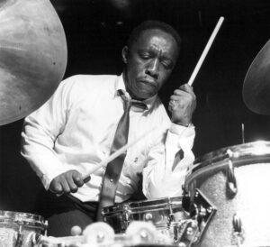 Black and white photograph of Art Blakey playing the drums.