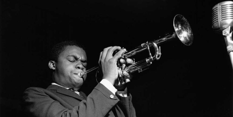 Black and white photograph of Freddie Hubbard playing the trumpet.