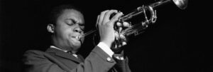 Black and white photograph of Freddie Hubbard playing the trumpet.