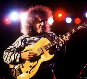 Colour portrait of guitarist Pete Metheny playing live