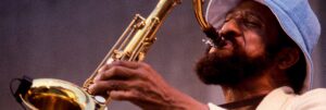 Colour photograph of Sonny Rollins playing the saxophone.