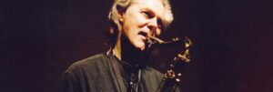 Colour portrait of ECM Records' jazz musician Jan Garbarek playing the saxophone.