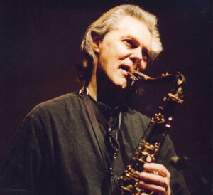 Colour portrait of ECM Records' jazz musician Jan Garbarek playing the saxophone.