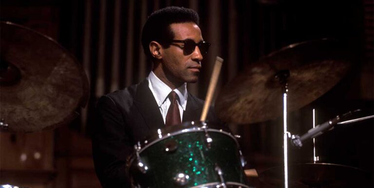 Colour portrait of Max Roach playing the drums