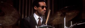 Colour portrait of Max Roach playing the drums