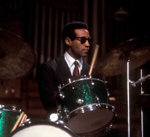 Colour portrait of Max Roach playing the drums