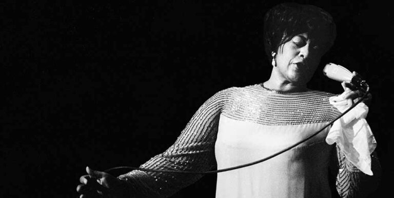 Black and white photograph of Jazz singer Ella Fitzgerald performing live.